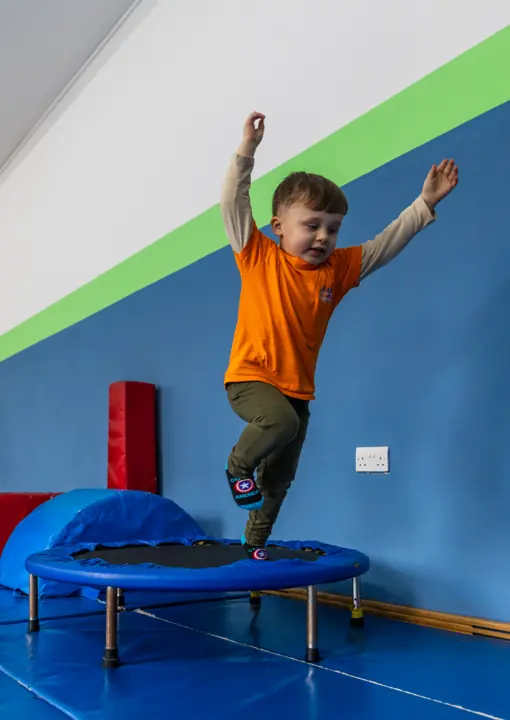 A boy jumping on a mini trampoline