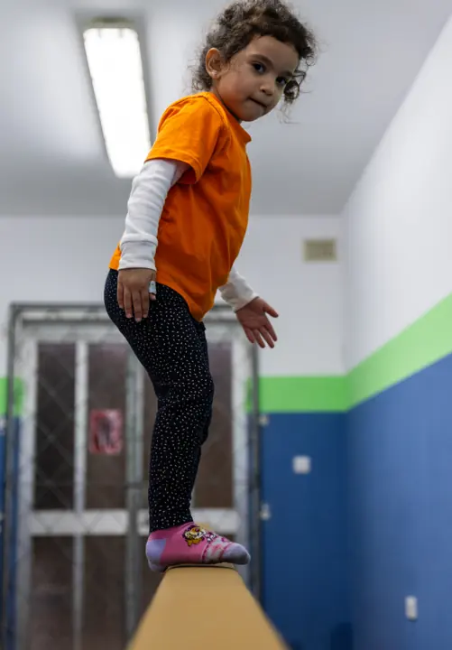 A girl walking along a balance beam