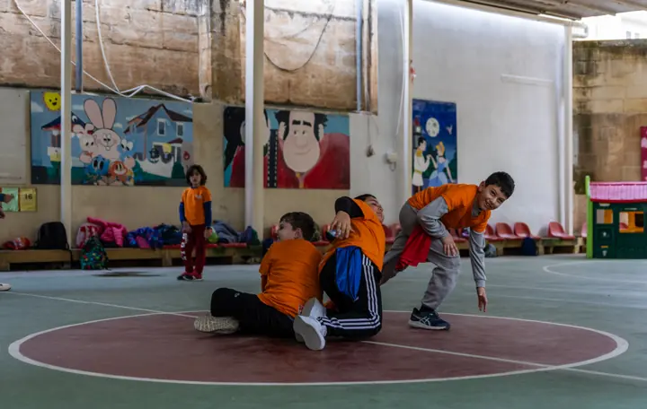 Children playing a game on the outdoor court