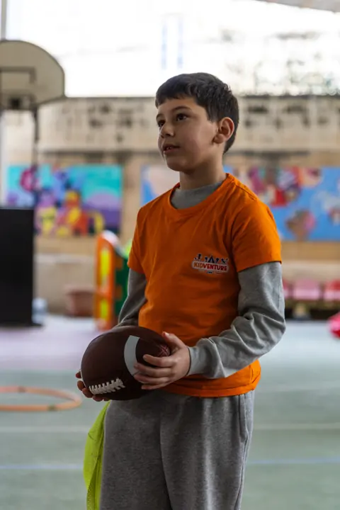 A boy holding an American football