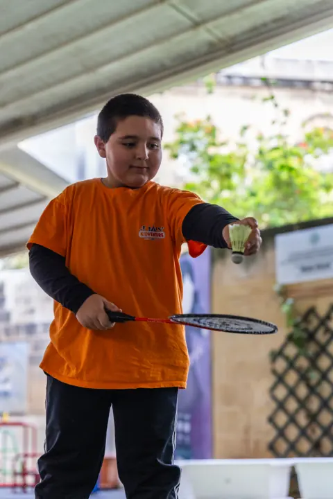 A boy playing badminton