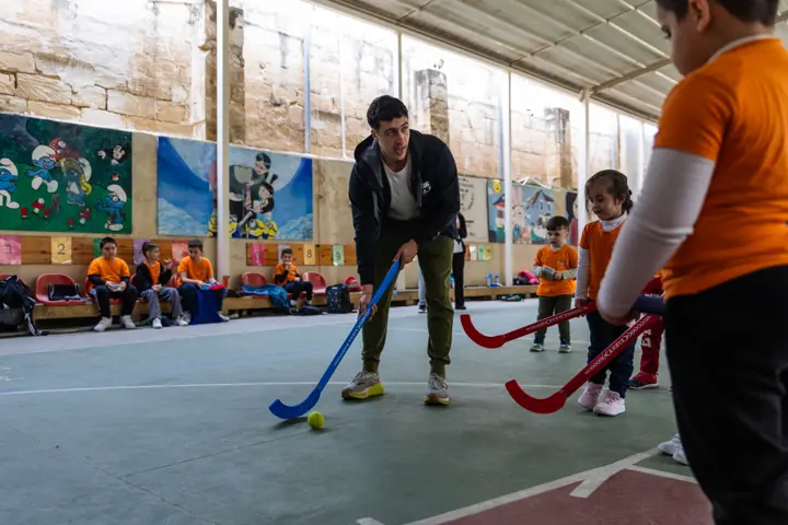 A coach leading a hockey game on the court