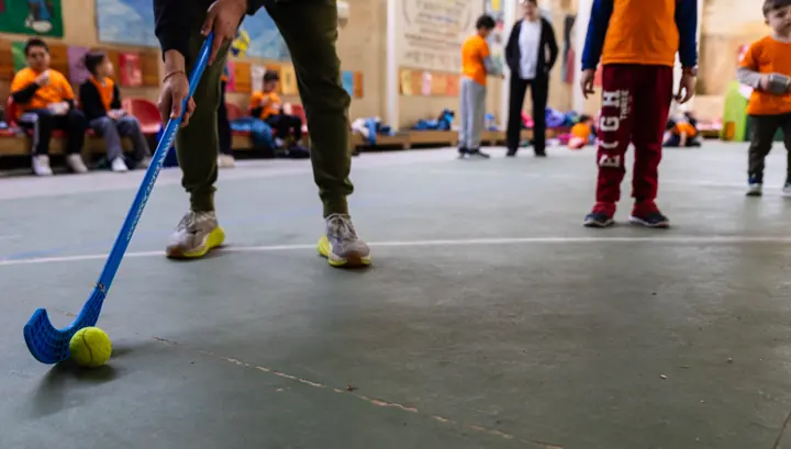 A hockey stick and ball on the court