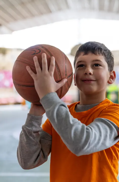 A boy getting ready to shoot a basketball