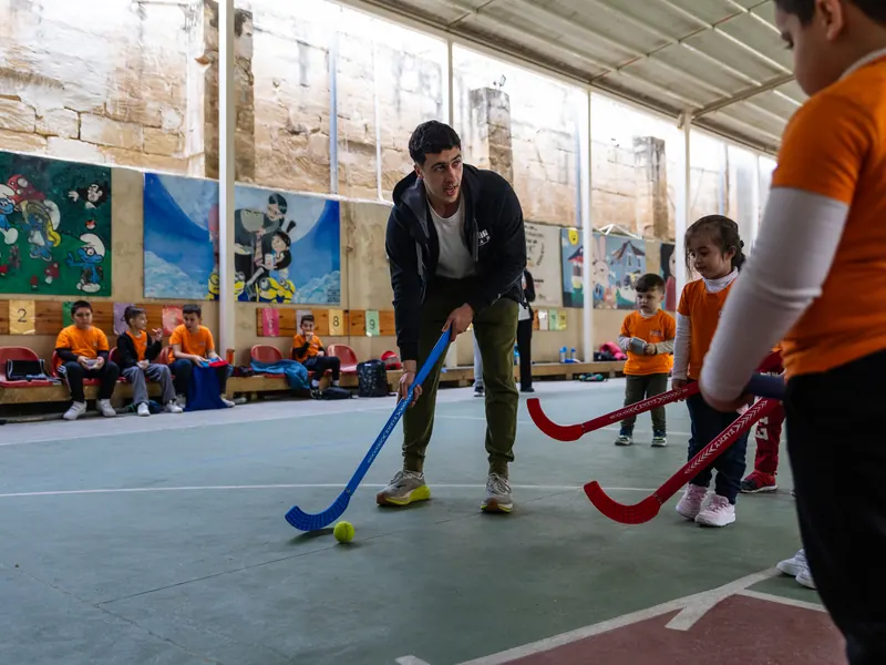 A coach leading a hockey game on the court
